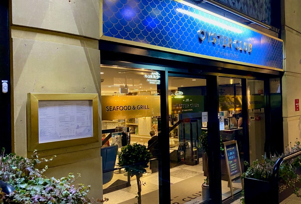Gold and blue frontage of The Oyster Club Restaurant
