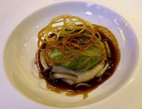 Cabbage leaf stuffed with guinea fowl in a mushroom jus and topped with a lattice of piped fried potato